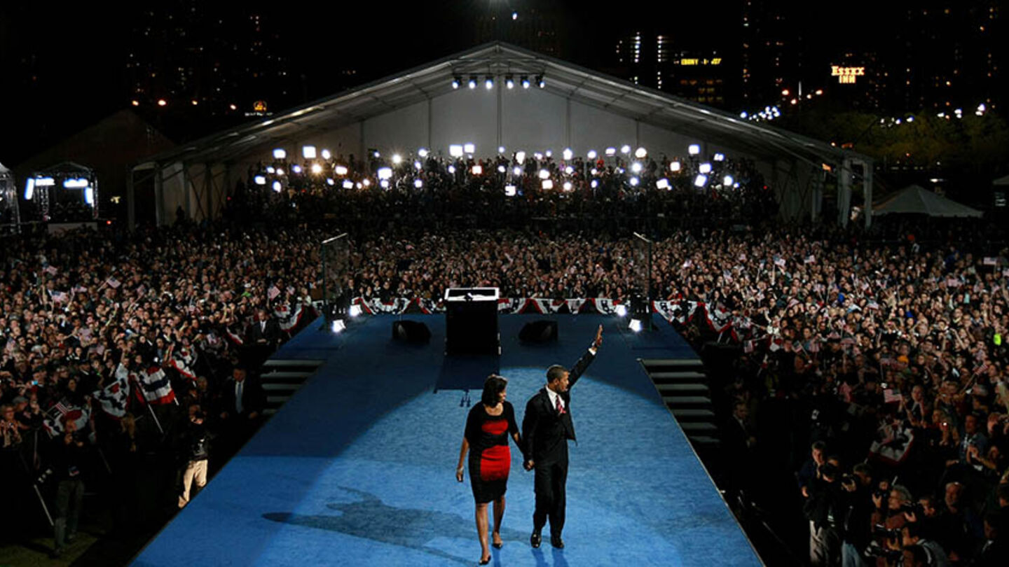 CHICAGO - NOVEMBER 04: U.S. President elect Barack Obama and his wife Michelle wave to the crowd as they walk off stage after Obama gave his victory speech during an election night gathering in Grant Park on November 4, 2008 in Chicago, Illinois. Obama defeated Republican nominee Sen. John McCain (R-AZ) by a wide margin in the election to become the first African-American U.S. President elect. (Photo by Justin Sullivan/Getty Images)